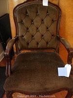 Full view of vintage brown upholstered side chair showing tufted back, armrests, and seat.