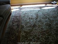 Full view of rug under couch showing overall size and pattern placement
