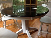 Overview of round marble top table with four chairs
