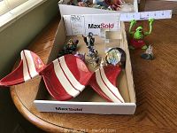 Photo showing the full assortment of decorative items on a round table, including ceramic candy dishes, glass cubes, and figurines.
