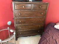 Front view of wood dresser with 6 drawers, showing condition and handles