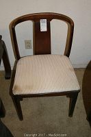 Front view of one Drexel wooden chair showing curved backrest and striped upholstered seat.