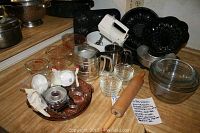 Overview of all bakeware items on kitchen counter including mixer, bowls, pans, and baking tools