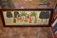Wide view showing both paintings leaning against a wall, details with people, trees, and cattle