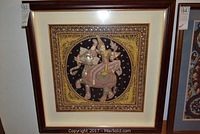 Full view of framed embroidered Thai wall art showing a figure on an elephant with decorative border and beads.