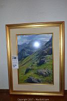 Frontal view of framed artwork showing mountain landscape