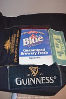 Bar advertising lot items arranged including four bar towels and wood framed Labbat's Blue display board.