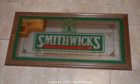 Rectangular bar mirror with Smithwick's logo in green, wooden frame, 30" x 16".