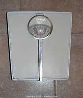 Top-down view of vintage Detecto scale showing white platform and round dial with chrome finish.