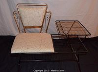 Full view of the metal telephone table with built-in cushioned seat and side mesh table surface.