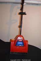 Full frontal view of the Toro Power Shovel showing the red body, black handle, and Toro label.