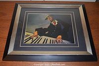 Framed print of the man playing piano, showing overall appearance of frame and matting.