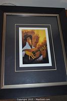 Framed print in black and metallic frame with black matte surrounding the print.