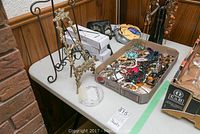 Overview photo of the jewellery, easels, and part of the masks and selfie sticks.