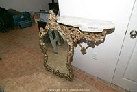 Shelf and mirror leaning against wall, full view of both pieces