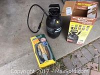 Photo showing black RL Flowmaster 5-gallon sprayer with hose and nozzle, original box, and accessory kit in packaging.