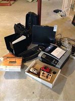 View of lot showing Viewsonic monitor, Microsoft keyboard, Brother multifunction printer, laptop bags, cameras, and cables.