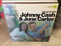 Front cover of the album showing Johnny Cash and June Carter smiling outdoors, with original price sticker $2.99 visible.