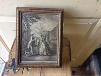 Front view of wooden shadow box with vintage storybook illustration lid showing a couple in period dress with a dog.
