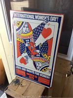 Full view of the International Women's Day 1979 poster showing the Queen of Hearts playing card design with feminist symbols and fist, text header and footer.
