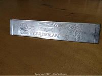 Front view showing embossed 'BIRTH CERTIFICATE' text with bear and floral designs on the silver plated holder.