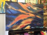 Front view of abstract artwork with vivid colors and dynamic brush strokes on canvas.