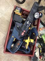 Overhead view of crate filled with Ryobi cordless tools and two yellow battery packs