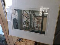 Framed large limited edition print depicting an architectural interior scene with plant and reflections, signed by Frances St Clair Miller.