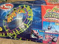 Photograph of the original product box showing an assembled image of the K'NEX Screamin Serpent motorized roller coaster set with product details.