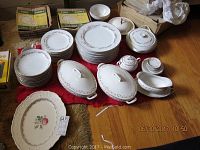 Photo shows the full collection including all listed china pieces and the platter on a wooden floor with boxes and a red cloth