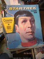 Photo of vintage Star Trek coloring book featuring Spock on the cover with attached Crayola crayons box.