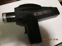 Black Remco Star Trek Phaser toy with silver 'Star Trek' lettering on the side.