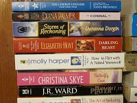 Stack of romance books showing various titles and authors