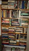 Full bookshelf showing densely packed vintage science fiction books including several Isaac Asimov titles and various other authors