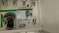Overview of control unit on countertop with multiple handpiece attachments hanging above