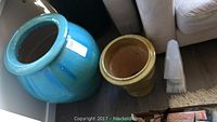 Photo of large turquoise pottery urn and chartreuse ceramic planter together, showing size and finish of each item.