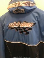 Rear view of blue/black/silver Ski-Doo snowmobile jacket with logo