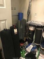 Overview of assorted exercise equipment including mats, bolsters, dumbbells, foam roller and booklets