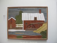 Frontal view of framed wood cut art featuring a watermill with a wheel, trees, and buildings; colors include white, brown, green, and gray