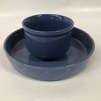 Two cobalt blue ceramic bowls stacked, smaller bowl inside the larger scalloped-edge bowl, glossy finish, no visible damage.