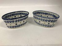Both oval stoneware containers side by side showing size and design