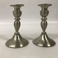 Photo of the pair of pewter candle holders showing their full shape and size.