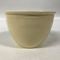 Side view photo of cream-colored Fiesta ceramic bowl showing exterior finish and concentric rings below rim.