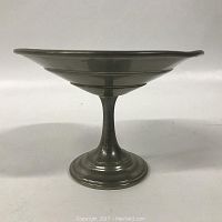 Side view of Pewter compote showing pedestal base and shallow flared bowl with concentric ring detail.