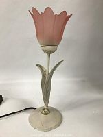 Full view of the pink tulip glass shade lamp showing the flower-shaped shade and cream-colored metal base with leaf detailing.