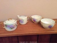 Cream and sugar set with two cups and one saucer, floral hand painted design with gold detail