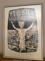 Framed black and white lithograph showing a figure holding a basket of bread on their head.