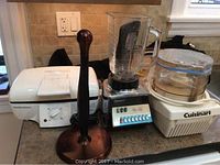 Photo showing Hamilton Beach grill, Osterizer blender, and Cuisinart food processor on countertop.