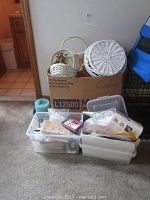 Full view of the lot showing boxes and plastic containers filled with multiple basket types and crafting supplies including stamps and stamp pads.