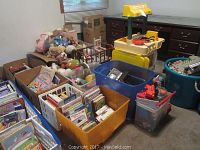 Overall view of the toys, books, stuffed animals, racing center, kitchen station, and bins packed with toys.